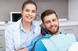 female dental hygienist smiling with male patient, Brentwood, TN family dentist, general dentist